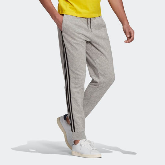 PANTALONI ESSENTIALS FRENCH TERRY TAPERED CUFF 3-STRIPES